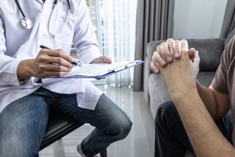 Doctor and patient are discussing consultation about symptom problem diagnosis of disease talk to the patient about medication and treatment method.